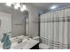 Bright bathroom with a large mirror, white shower curtain, and modern fixtures at 470 Wagon Hill Ln, Sugar Hill, GA 30518