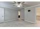 Bedroom has neutral carpet, ceiling fan, and bathroom access at 470 Wagon Hill Ln, Sugar Hill, GA 30518