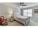 Cozy bedroom featuring a wood bed frame, ceiling fan, and ample natural light at 470 Wagon Hill Ln, Sugar Hill, GA 30518