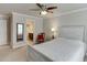 Bedroom with a wood bed frame, neutral carpet, and an adjoining bathroom at 470 Wagon Hill Ln, Sugar Hill, GA 30518