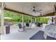 Relaxing covered patio with seating, ceiling fans, outdoor dining, and a lovely view of the pool at 470 Wagon Hill Ln, Sugar Hill, GA 30518