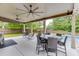 Charming covered patio with ceiling fans, outdoor dining area, rocking chairs, and a view of the pool at 470 Wagon Hill Ln, Sugar Hill, GA 30518