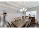 Well-lit dining room features crown molding, decorative lighting, and hardwood floors at 470 Wagon Hill Ln, Sugar Hill, GA 30518
