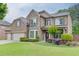 Charming two-story brick home featuring manicured lawn and landscape and a three car garage at 470 Wagon Hill Ln, Sugar Hill, GA 30518