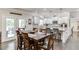 Eat-in kitchen with island, dining table, white cabinets, and stainless appliances at 470 Wagon Hill Ln, Sugar Hill, GA 30518
