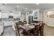Well-lit eat-in kitchen featuring white cabinets, stainless appliances, island, and dining area at 470 Wagon Hill Ln, Sugar Hill, GA 30518