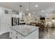 Open concept kitchen featuring island with seating, stainless appliances, and casual living space at 470 Wagon Hill Ln, Sugar Hill, GA 30518