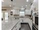 Bright kitchen features granite countertops, stainless steel appliances, and ample white cabinetry at 470 Wagon Hill Ln, Sugar Hill, GA 30518