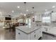 Open kitchen with eat-in island overlooking dining area and living room at 470 Wagon Hill Ln, Sugar Hill, GA 30518