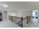 Landing area with dark wood banister and neutral carpet leads to multiple rooms at 470 Wagon Hill Ln, Sugar Hill, GA 30518