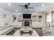 Cozy living room with built-in shelving, fireplace, hardwood floors, and comfortable seating, perfect for relaxation at 470 Wagon Hill Ln, Sugar Hill, GA 30518