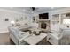 Inviting living room with a stone fireplace, plush seating, and built-in shelving at 470 Wagon Hill Ln, Sugar Hill, GA 30518
