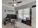 Light filled office boasts carpet, neutral walls, ceiling fan and large desk with computer equipment at 470 Wagon Hill Ln, Sugar Hill, GA 30518