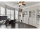 Bright home office featuring hardwood flooring, built-in bookshelves, and large windows for natural light at 470 Wagon Hill Ln, Sugar Hill, GA 30518