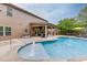 Backyard pool with water features, patio seating and covered area for relaxing or entertaining at 470 Wagon Hill Ln, Sugar Hill, GA 30518