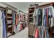 Spacious walk-in closet with custom built-in shelving, multiple storage options, and ample space for organization at 470 Wagon Hill Ln, Sugar Hill, GA 30518