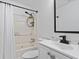 Bathroom featuring a shower-tub combination, toilet, sink, and black fixtures and decorative elements at 3775 Reston Ln, Decatur, GA 30034