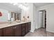 Double vanity bathroom with tile flooring, dark wood cabinetry and a framed mirror at 397 Victory Ln Ln, Locust Grove, GA 30248