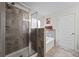 Tiled bathroom with glass enclosed shower and a soaking tub under a picture window at 397 Victory Ln Ln, Locust Grove, GA 30248
