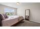 Neutral bedroom with a large mirror, window, plush carpet, and neutral bedding at 397 Victory Ln Ln, Locust Grove, GA 30248