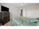 Comfortable bedroom with a large TV and neutral tones for a relaxing retreat at 397 Victory Ln Ln, Locust Grove, GA 30248