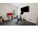 Exercise room with rubber flooring, a stationary bike, tv, and storage at 397 Victory Ln Ln, Locust Grove, GA 30248