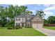 Charming two-story home featuring a well-manicured lawn and attached two-car garage at 397 Victory Ln Ln, Locust Grove, GA 30248