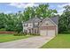 Traditional two-story home featuring an attached two-car garage and a well-maintained lawn at 397 Victory Ln Ln, Locust Grove, GA 30248