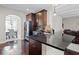 Open kitchen features dark cabinetry, black countertops, stainless steel appliances, and hardwood floors at 397 Victory Ln Ln, Locust Grove, GA 30248