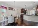 Kitchen and breakfast nook with hardwood floors, dark cabinets, black countertops, and lots of natural light at 397 Victory Ln Ln, Locust Grove, GA 30248