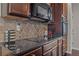 Close up of this kitchen showing stainless steel appliances, granite countertops, and dark wood cabinets at 397 Victory Ln Ln, Locust Grove, GA 30248
