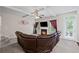 Spacious living room with fireplace, TV, ceiling fan, and large sectional sofa at 397 Victory Ln Ln, Locust Grove, GA 30248