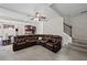 Open-concept living room featuring a sectional sofa, staircase, and views to the kitchen and dining at 397 Victory Ln Ln, Locust Grove, GA 30248