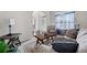 Bright living room features comfortable seating, side tables, and view to entry at 397 Victory Ln Ln, Locust Grove, GA 30248