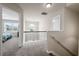 Bright and open loft with a view of a bedroom, featuring a decorative railing at 397 Victory Ln Ln, Locust Grove, GA 30248