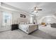 A spacious main bedroom with a sitting area, carpet, ceiling fan and large picture window at 397 Victory Ln Ln, Locust Grove, GA 30248