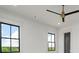A bright bedroom features high ceilings, a modern ceiling fan and two large windows at 4927 Slaton Dr, Acworth, GA 30101