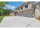 Long driveway leading to a three-car garage with decorative doors and brick facade at 4927 Slaton Dr, Acworth, GA 30101