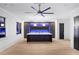 Game room features dark cabinetry, a large island, recessed lighting, and a putting green at 4927 Slaton Dr, Acworth, GA 30101