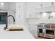 Close up view of the large stone island and chef's stove at 4927 Slaton Dr, Acworth, GA 30101