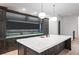 Modern kitchen island with custom cabinetry, stone countertops, and stylish pendant lighting for an elegant touch at 4927 Slaton Dr, Acworth, GA 30101