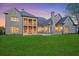 Beautiful rear exterior featuring an expansive patio with lush lawn, complemented by the home's elegant architectural details at 4927 Slaton Dr, Acworth, GA 30101