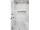 Modern steam shower with white tiled walls, gold fixtures, and multiple shower heads for a spa-like experience at 4927 Slaton Dr, Acworth, GA 30101