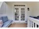 Cozy back porch with seating and French doors leading inside at 620 Neel Reid Dr, Roswell, GA 30075