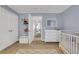 Bright Bedroom with ample storage, a changing table, and soft, calming color palette at 620 Neel Reid Dr, Roswell, GA 30075