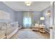 Serene Bedroom features a crib, comfortable seating, soft colors, and natural light at 620 Neel Reid Dr, Roswell, GA 30075