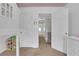 Cozy bedroom featuring a charming lofted bed and neutral decor with a peek into the hallway at 620 Neel Reid Dr, Roswell, GA 30075