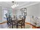 Bright dining room featuring a modern chandelier, neutral walls, and hardwood floors at 620 Neel Reid Dr, Roswell, GA 30075