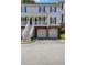 Townhouse exterior with brick base, garage, and upstairs entrance at 620 Neel Reid Dr, Roswell, GA 30075