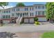 Charming townhome with brick accents, multiple garage spaces, and a welcoming front porch at 620 Neel Reid Dr, Roswell, GA 30075